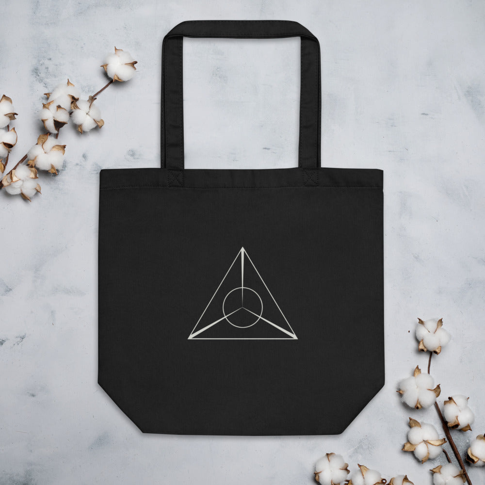 A minimalist black line art design of an equilateral triangle with intersecting lines printed on a tote bag. Flat lay, Ink colourway.