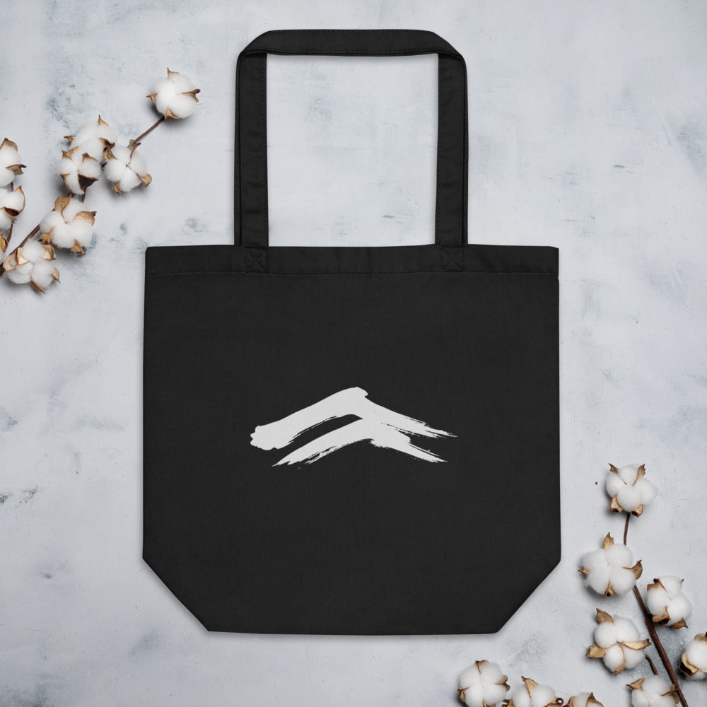 A minimalist sumi-e painting of two dry-brush mountain ridges printed on a tote bag. Flat lay, Ink colourway.
