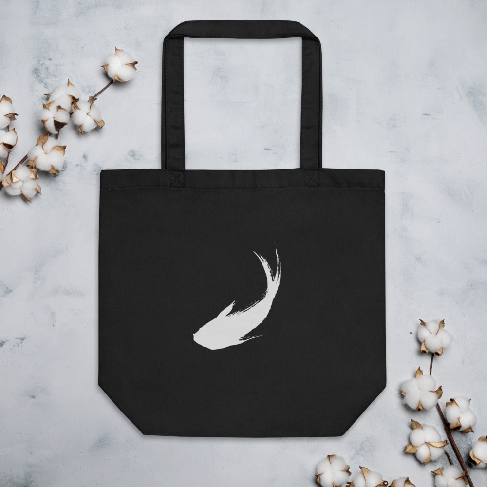 A minimal sumi-e ink brush painting of a single ascending carp printed on a tote bag. Flat lay, Ink colourway.