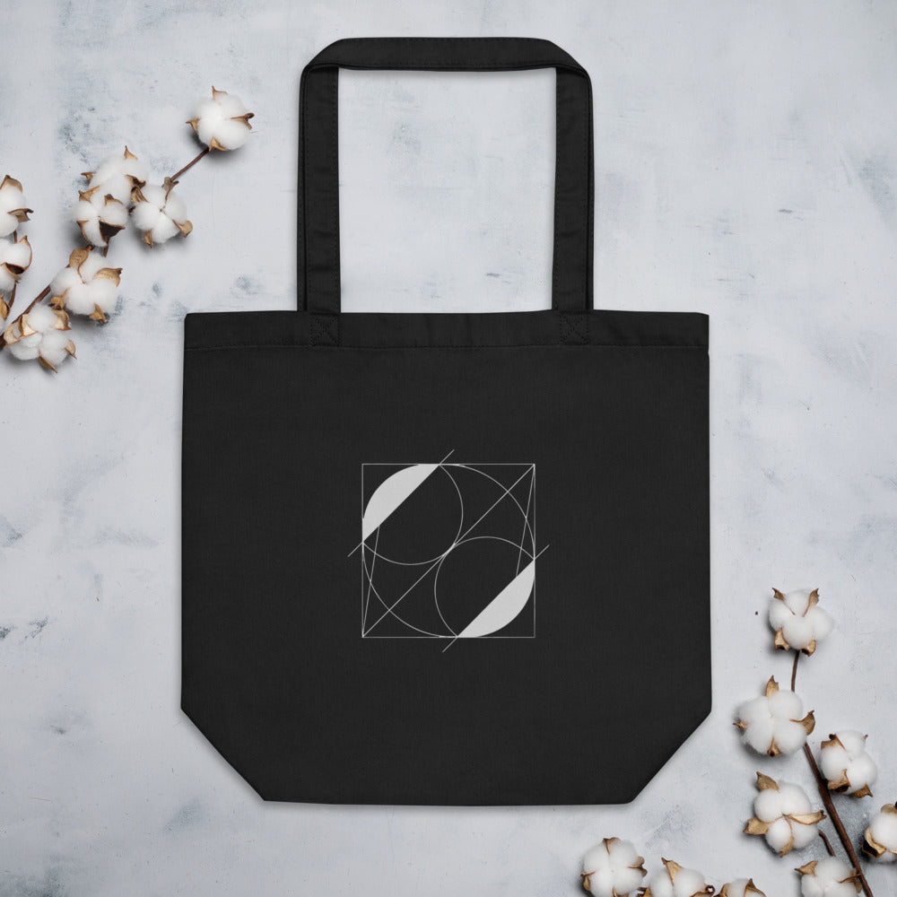 A vector line art design of intersecting crescent-shaped lunettes over a right triangle on a tote bag. Flat lay, Ink colourway.