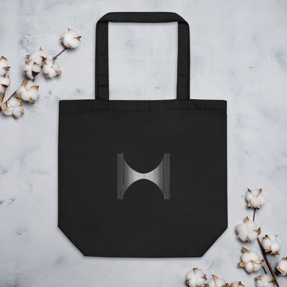 A field of vertical parallel lines deflected at the center by a Lorentzian curve, printed on a tote bag. Flat lay, Ink colourway.