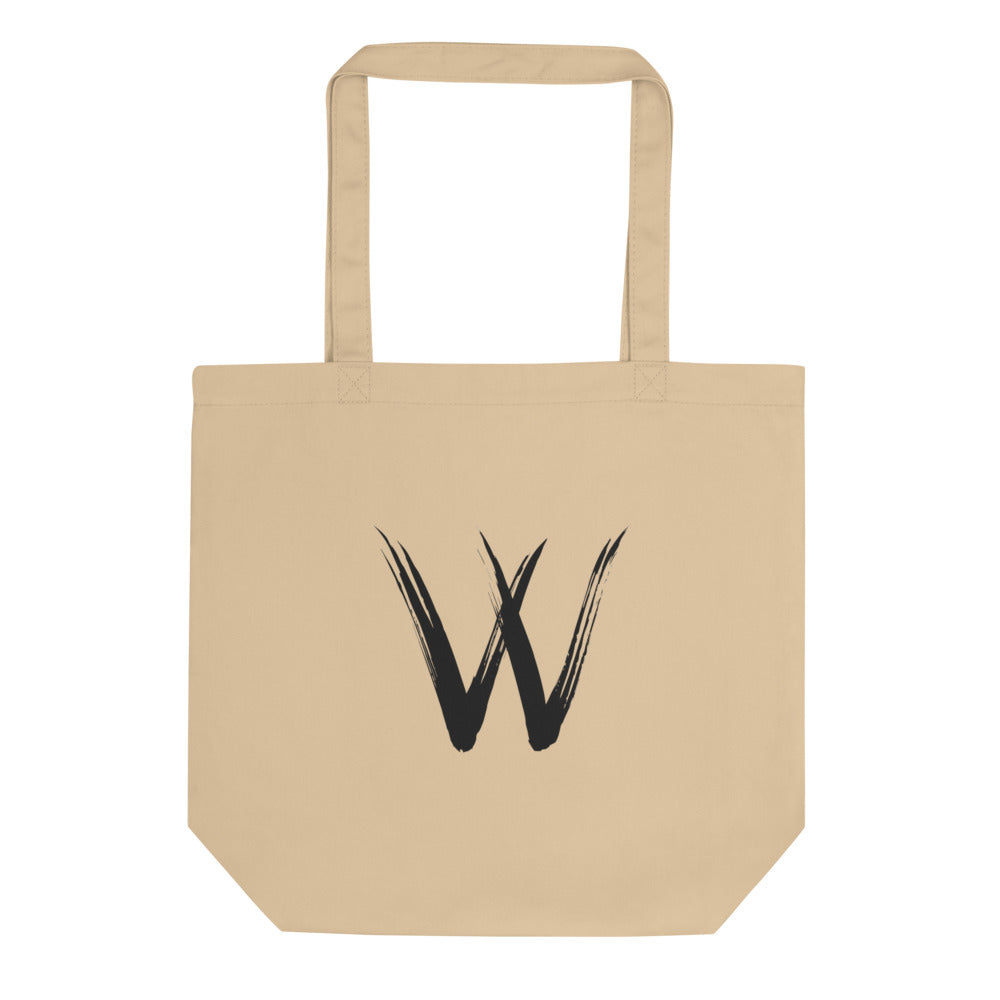 A minimalist sumi-e brush stroke design of the capital letter W printed on a tote bag. Shown on the Bone (Oyster) colorway.