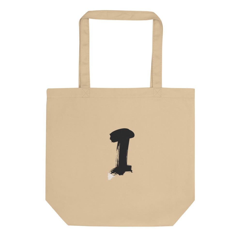 The letter I in a single vertical sumi-e brush gesture, printed on a canvas tote bag. Shown on the Bone (Oyster) colorway.