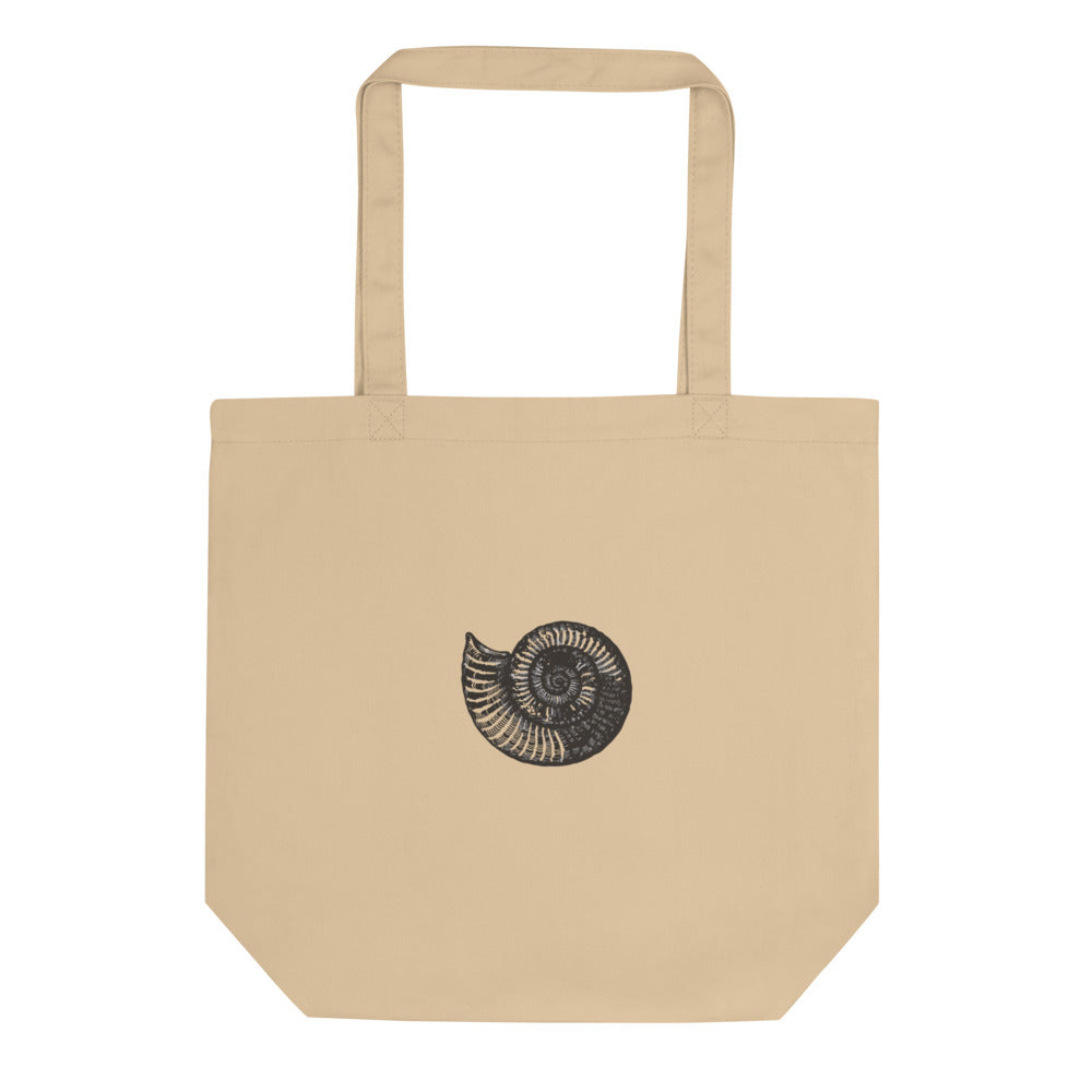A canvas tote bag printed with a black line art illustration of a Scaphites nodosus ammonite shell. Shown on the Bone (Oyster) colorway.