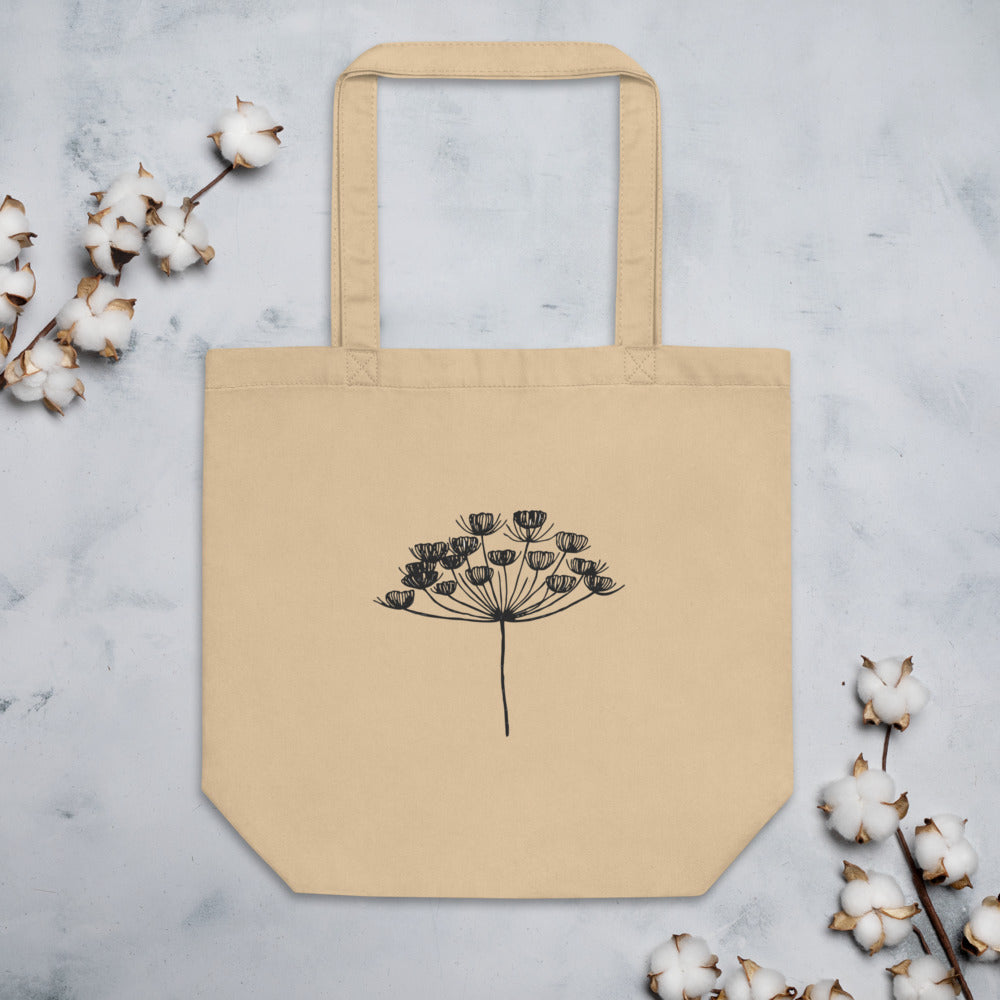 A fine-line botanical drawing of a dill seed umbel printed on a cotton tote bag. Flat lay, Bone colourway.