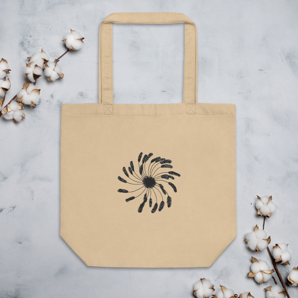 A clematis seed head design with delicate feathery achenes printed on a flat cotton tote bag. Flat lay, Bone colourway.