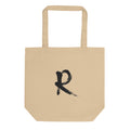 A minimalist sumi-e brush stroke design of the capital letter R printed on a tote bag. Shown on the Bone (Oyster) colorway.