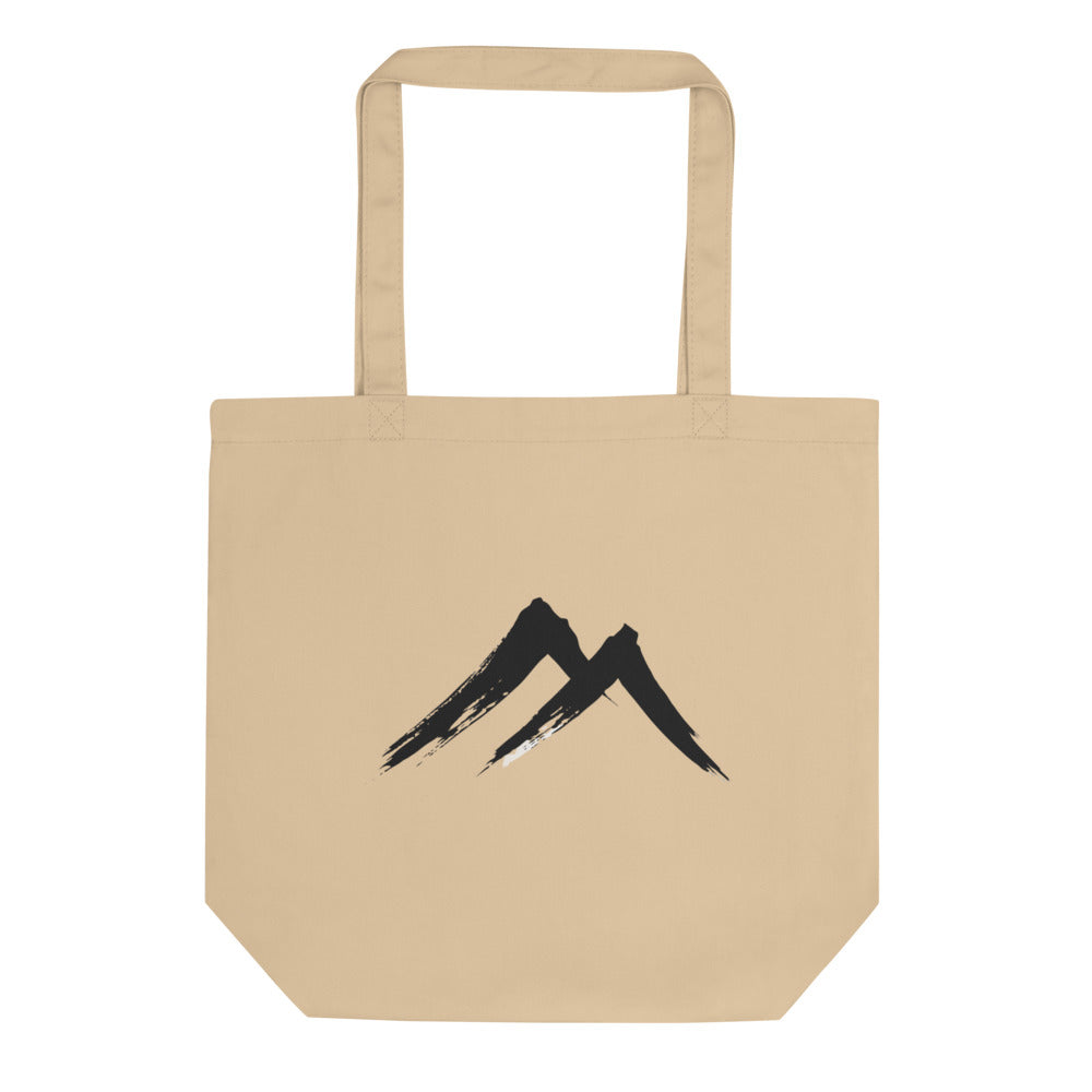 A sharp, two-stroke sumi-e mountain peak design printed on a tote bag. Shown on the Bone (Oyster) colorway.