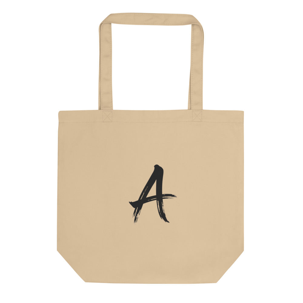 A minimalist sumi-e brush art design of the letter A printed on a fabric tote bag. Shown on the Bone (Oyster) colorway.