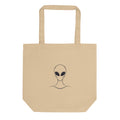 A minimalist line drawing of an alien head with black eyes and a high collar printed on a tote bag. Shown on the Bone (Oyster) colorway.