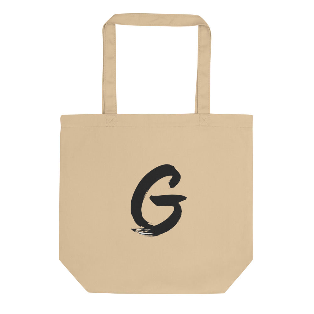 Sumi-e brush stroke of the capital letter G printed on a tote bag. Shown on the Bone (Oyster) colorway.