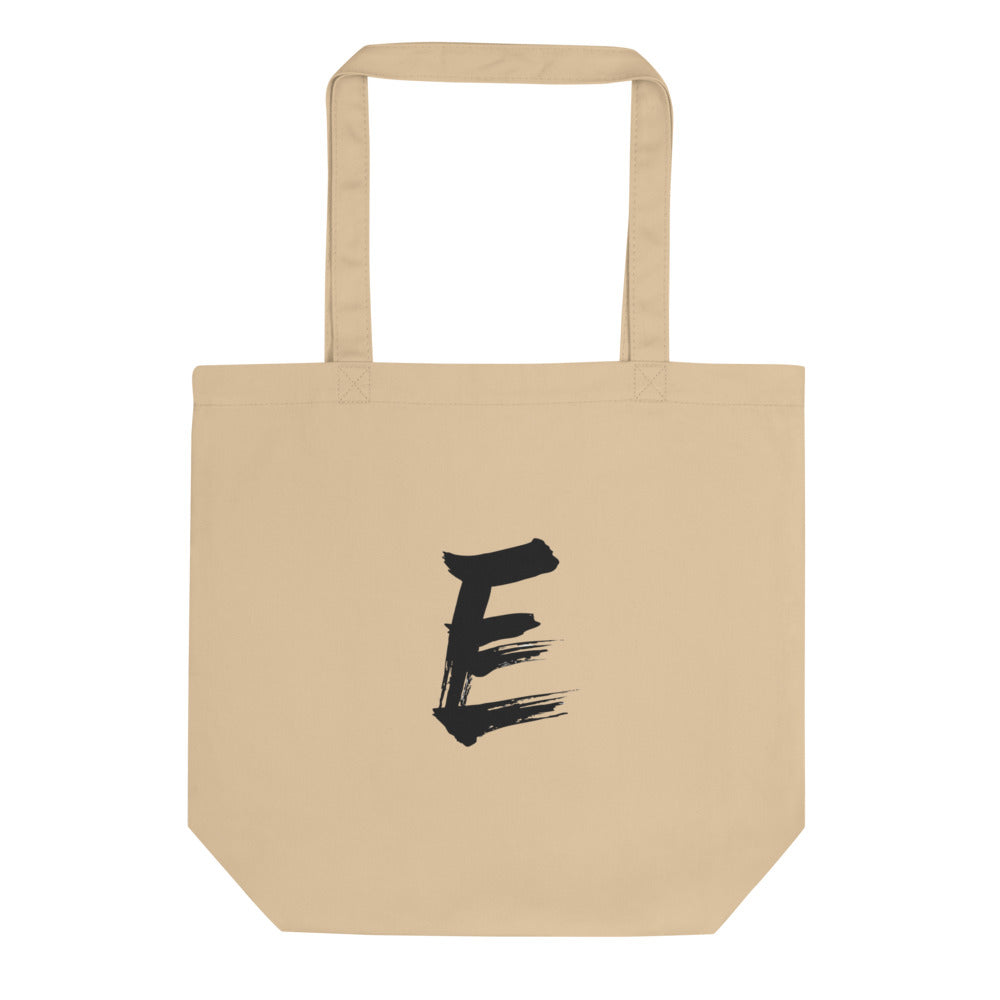 A minimalist sumi-e style capital letter E printed in black ink on a tote bag. Shown on the Bone (Oyster) colorway.