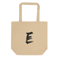 A minimalist sumi-e style capital letter E printed in black ink on a tote bag. Shown on the Bone (Oyster) colorway.
