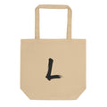 A black sumi-e brushstroke of the letter L printed on a simple tote bag. Shown on the Bone (Oyster) colorway.