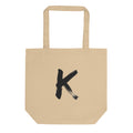 Sumi-e ink brush painting of the capital letter K printed on a canvas tote bag. Shown on the Bone (Oyster) colorway.