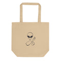 Minimalist waving visitor line art design of an alien with almond eyes raising a hand, printed on a tote bag. Shown on the Bone (Oyster) colorway.