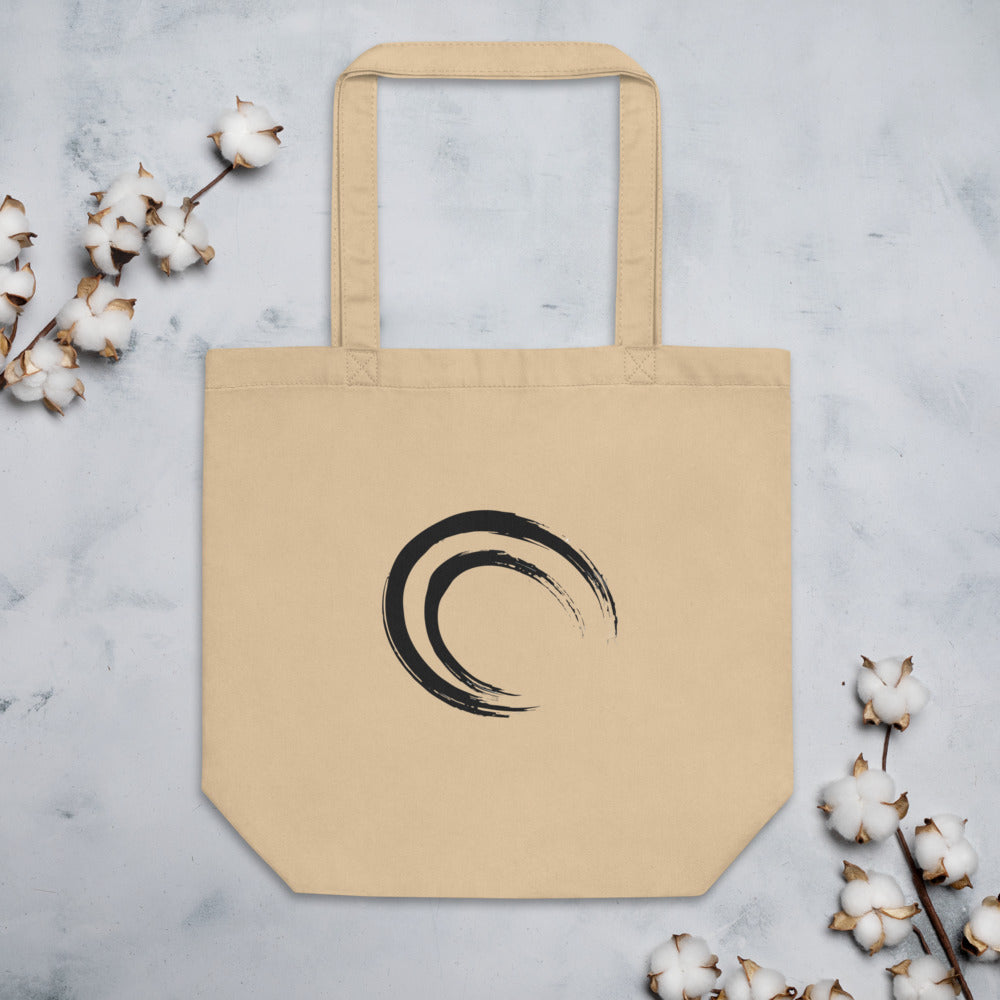 A double-layered crescent enso sumi-e design printed on a canvas tote bag. Flat lay, Bone colourway.