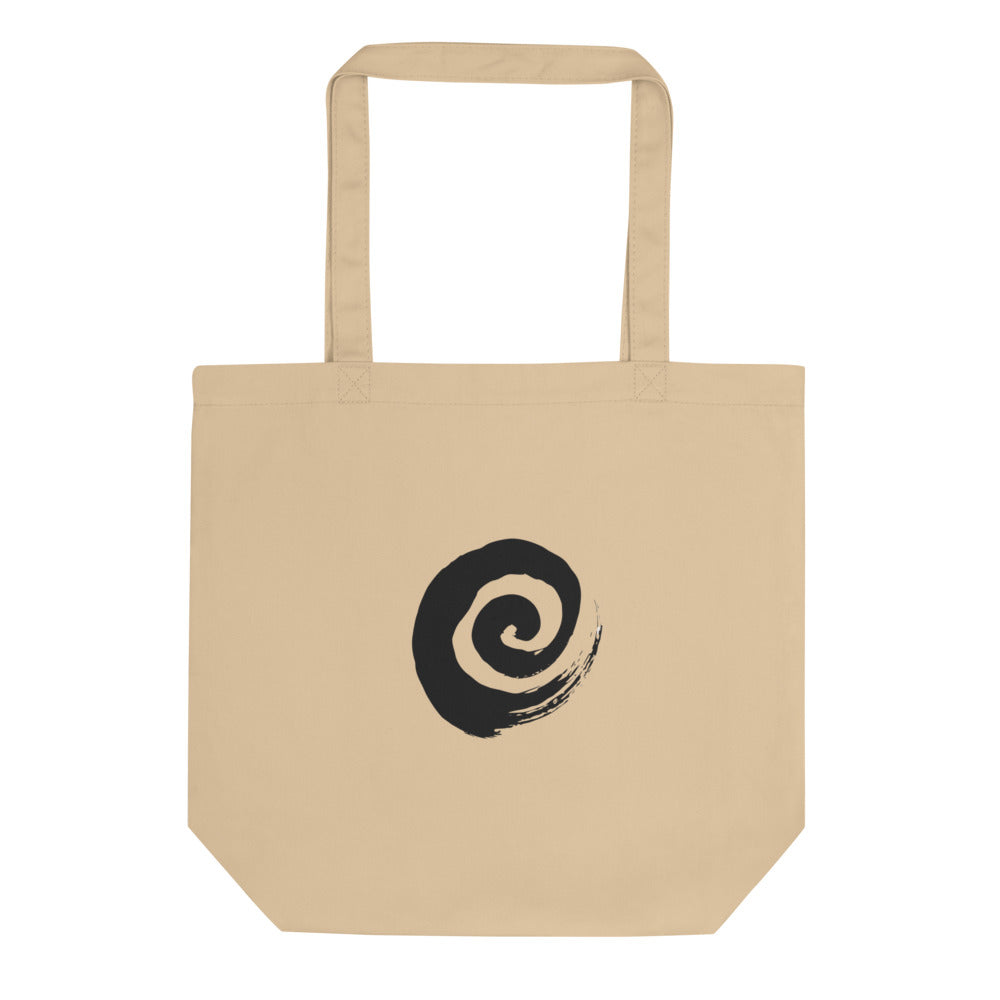 A minimal sumi-e spiral representing a coiled snail shell printed on a tote bag. Shown on the Bone (Oyster) colorway.