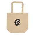 A minimal sumi-e spiral representing a coiled snail shell printed on a tote bag. Shown on the Bone (Oyster) colorway.
