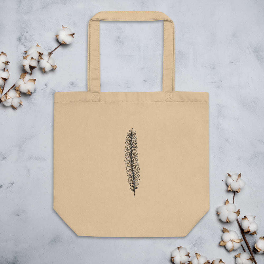 A botanical illustration of a running clubmoss vegetative branchlet printed on a tote bag. Flat lay, Bone colourway.