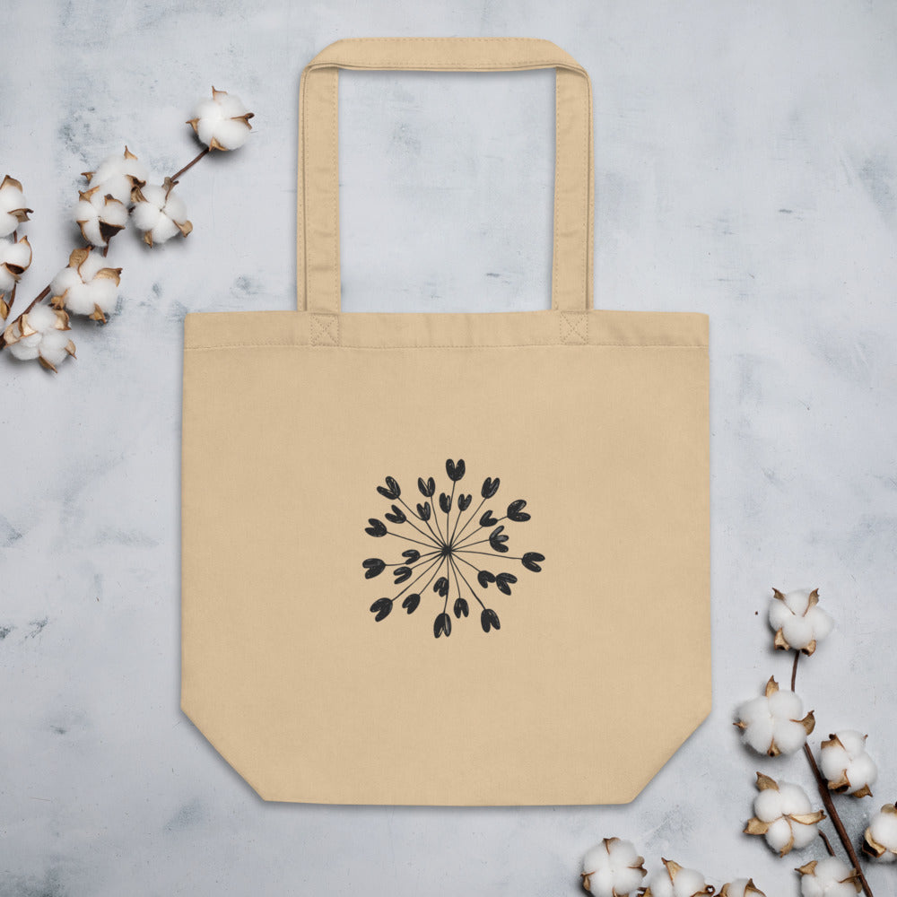 Fine hairline drawing of a lovage seed umbellule with radiating stems and ribbed seeds on a tote bag. Flat lay, Bone colourway.