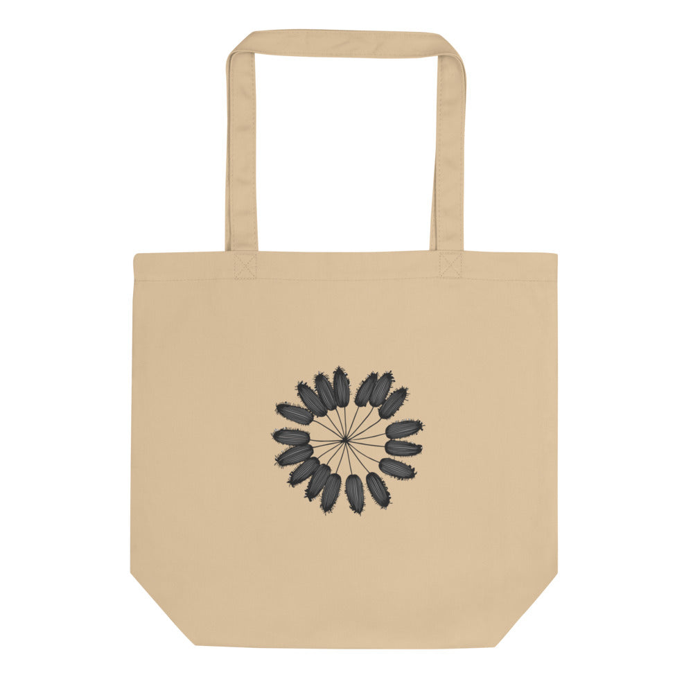 A detailed botanical line art illustration of a cumin seed umbellule printed on a tote bag. Shown on the Bone (Oyster) colorway.