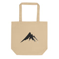 A sharp, minimalist sumi-e ink drawing of a jagged mountain peak printed on a tote bag. Shown on the Bone (Oyster) colorway.