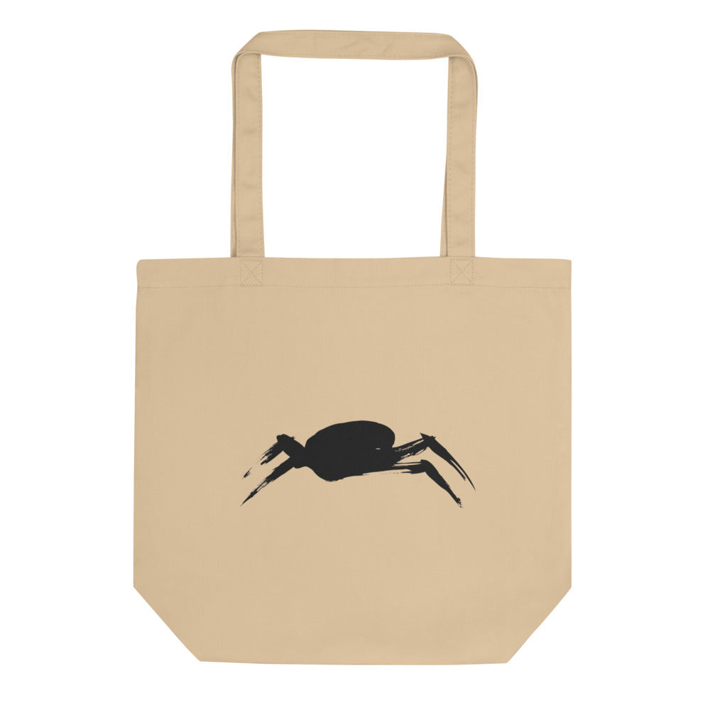 A minimalist sumi-e ink painting of a crab shell and legs printed on a tote bag. Shown on the Bone (Oyster) colorway.