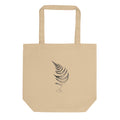 A wood fern engraving featuring detailed root structures and arched fronds, printed on a tote bag. Shown on the Bone (Oyster) colorway.