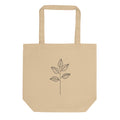A minimal black ink illustration of a single eucalyptus stem with four ovate leaves on a tote bag. Shown on the Bone (Oyster) colorway.