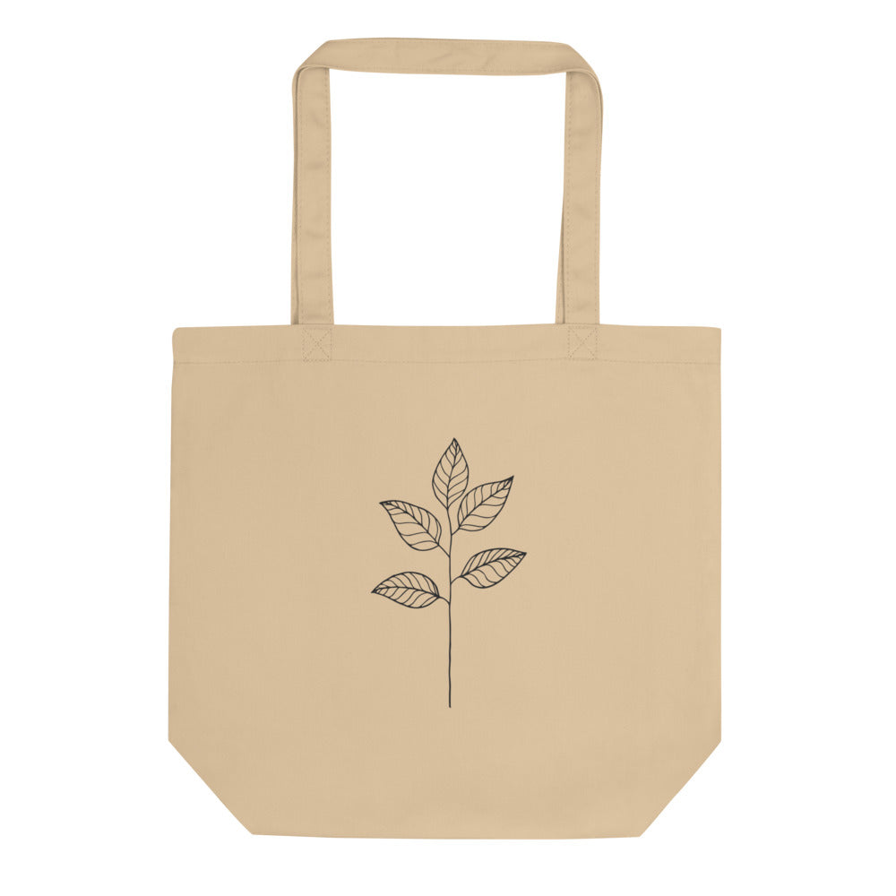 A minimal black ink illustration of a single eucalyptus stem with four ovate leaves on a tote bag. Shown on the Bone (Oyster) colorway.