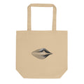 An engraving-style topographic contour design forming an asymmetric eye printed on a tote bag. Shown on the Bone (Oyster) colorway.