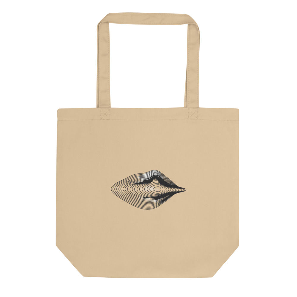 An engraving-style topographic contour design forming an asymmetric eye printed on a tote bag. Shown on the Bone (Oyster) colorway.