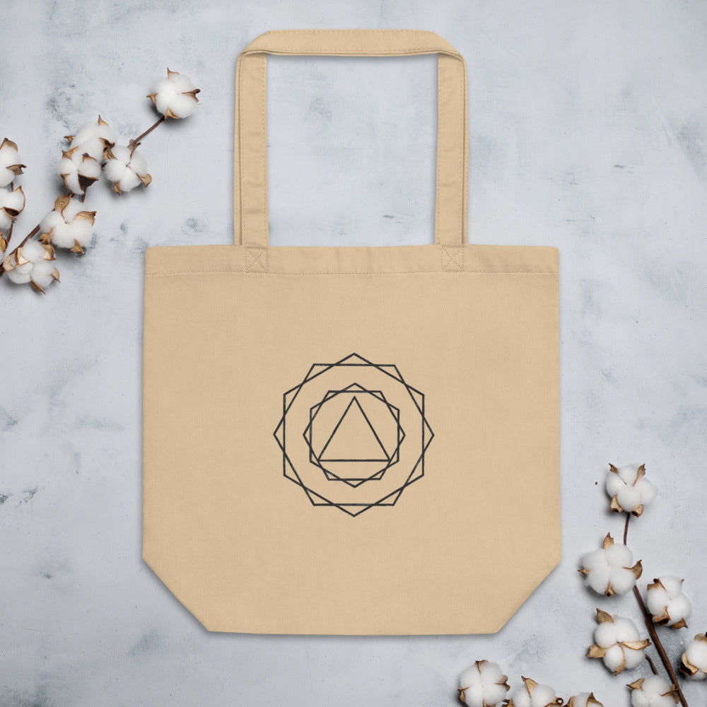 A nested progression of regular polygons from a central triangle to a 24-gon in crisp vector lines on a tote bag. Flat lay, Bone colourway.