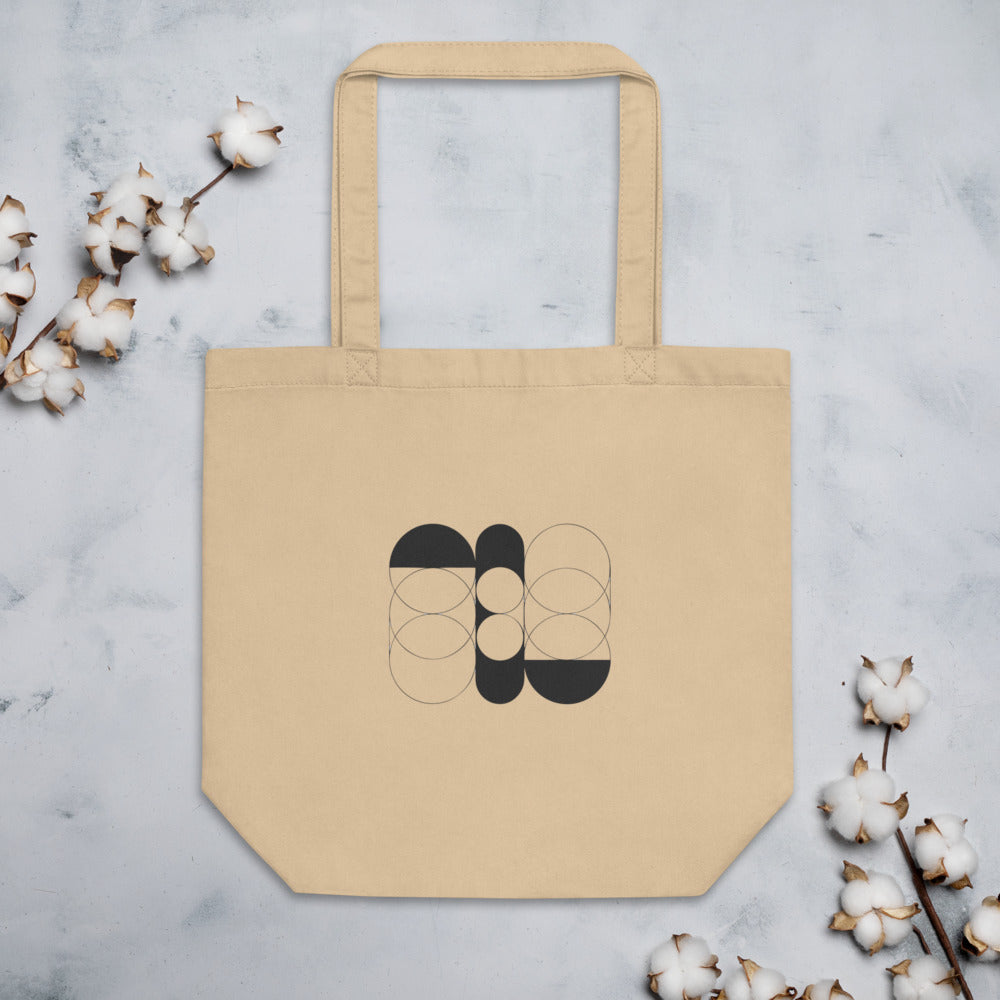 A sequence of nested Cassini ovals in fine hairline weight, transitioning from two loops to a flattened ellipse on a tote bag. Flat lay, Bone colourway.