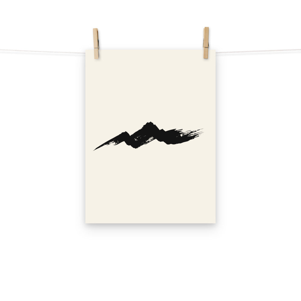 A single horizontal fractured dry-brush sumi-e ink stroke representing a rugged mountain ridge, printed on an art print. Hung with wooden pegs, 12″×16″ size.