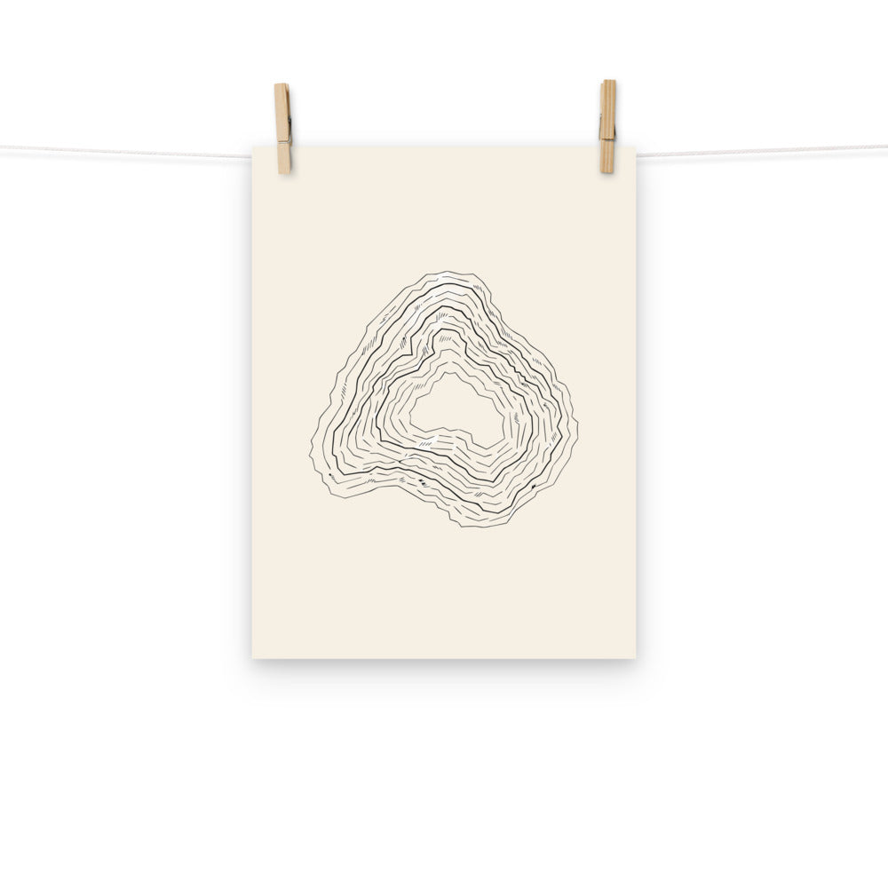 A minimalist topographic contour map design depicting a karst uvala depression on an art print. Hung with wooden pegs, 12″×16″ size.