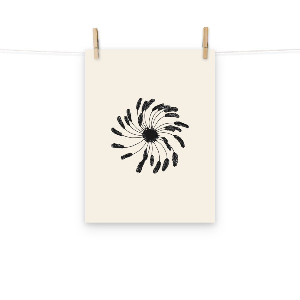 A minimalist art print featuring a central clematis seed head with fine feathery lines on an off-white background. Hung with wooden pegs, 12″×16″ size.