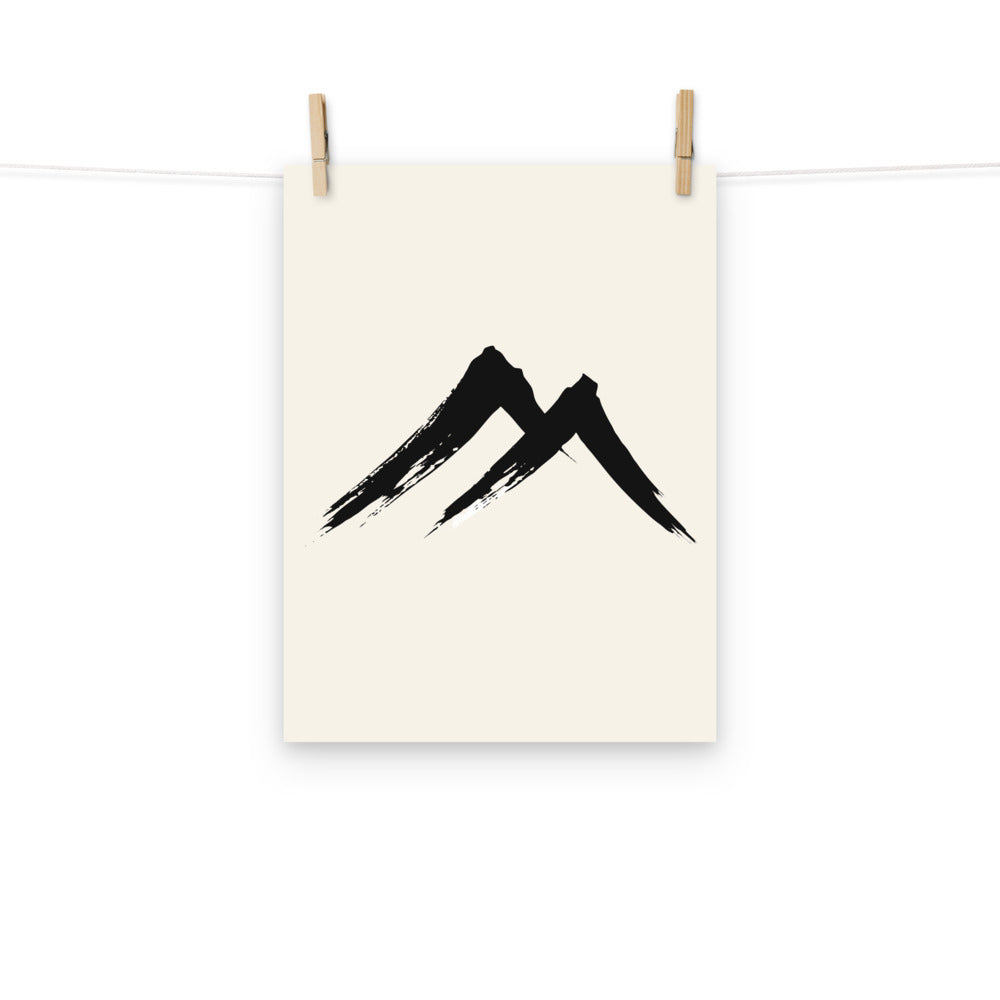 A sharp, two-stroke sumi-e mountain peak design printed on an art print. Hung with wooden pegs, 12″×16″ size.