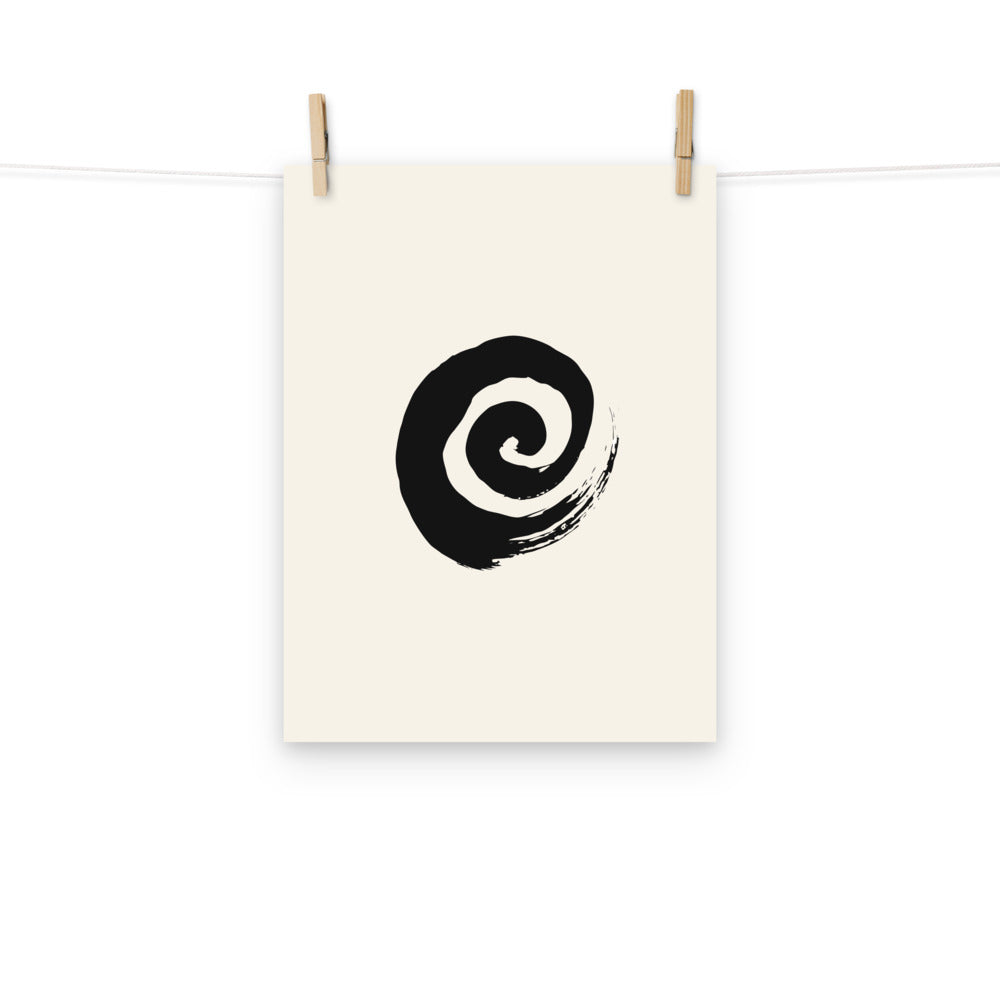 A minimal sumi-e spiral representing a coiled snail shell printed on an art print. Hung with wooden pegs, 12″×16″ size.