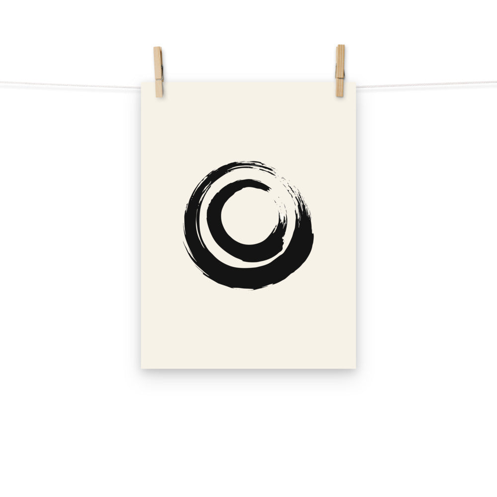 A nested double circle sumi-e brushstroke design printed on an art print. Hung with wooden pegs, 12″×16″ size.