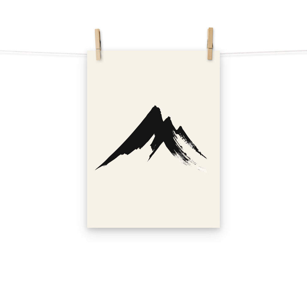 A minimalist sumi-e design of a jagged mountain peak printed on a fine art print. Hung with wooden pegs, 12″×16″ size.