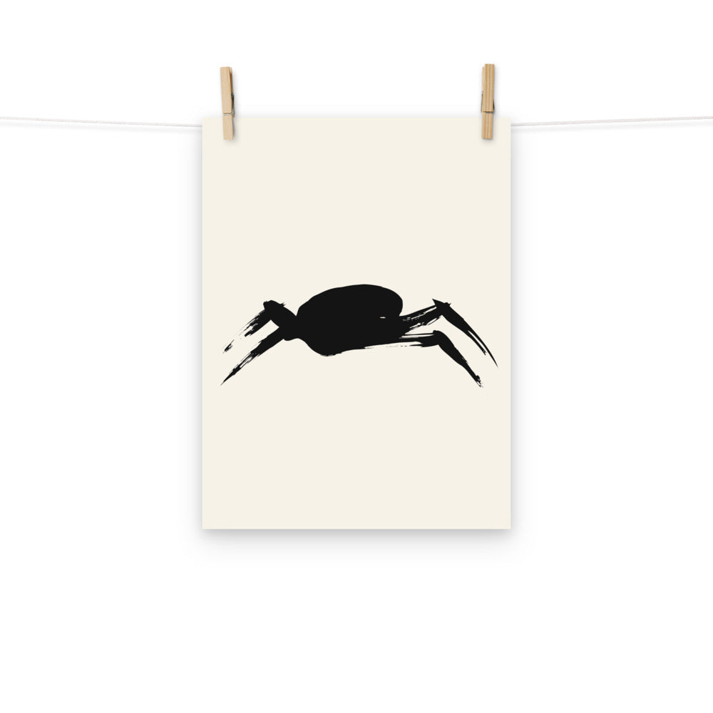 A minimalist sumi-e ink painting of a crab shell and legs on an art print. Hung with wooden pegs, 12″×16″ size.