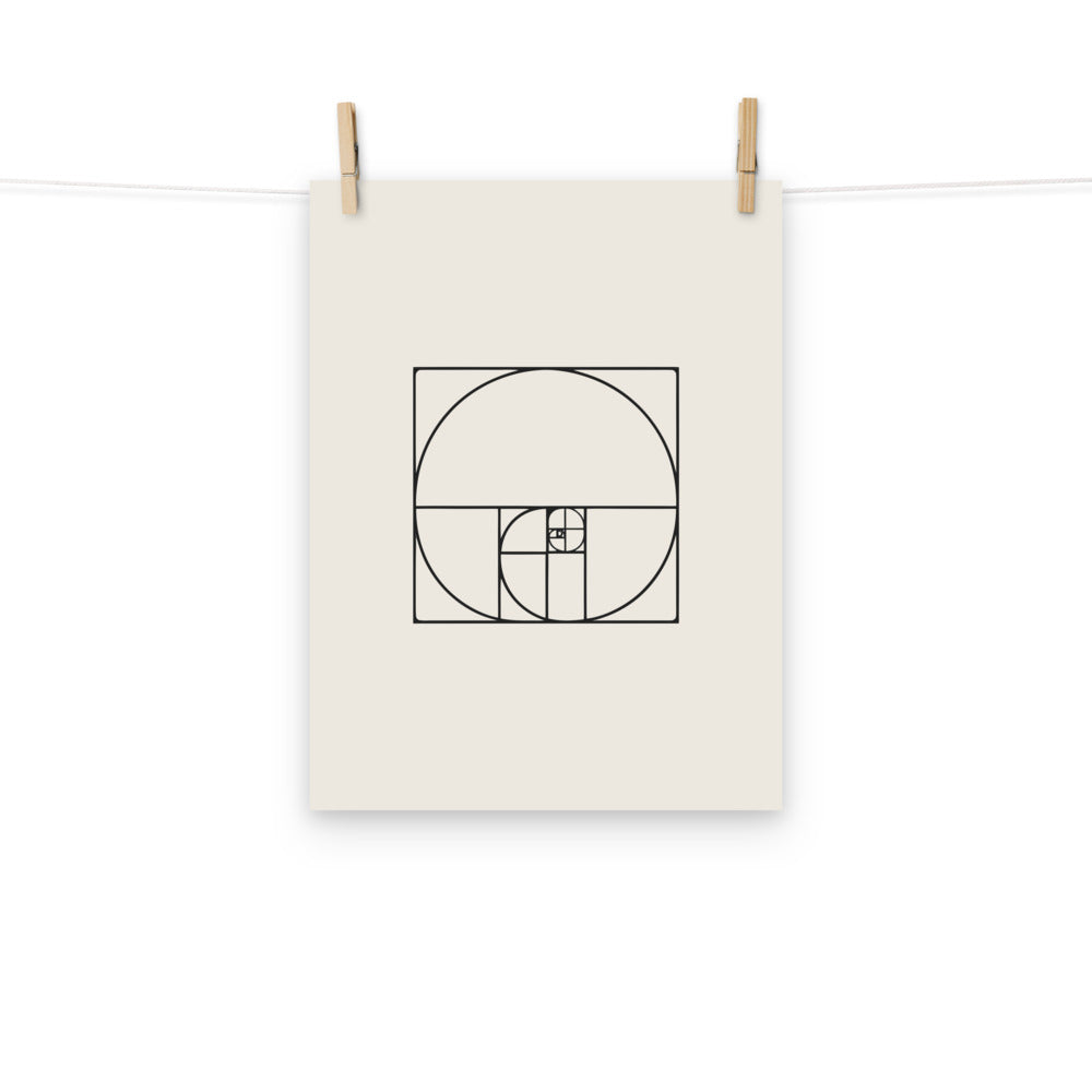A minimalist geometric design featuring nesting Fibonacci squares and a sweeping logarithmic arc in fine hairline lines on an art print. Hung with wooden pegs, 12″×16″ size.