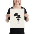 A black sumi-e ink painting of a swimming tadpole with a thick head and dry-brush tail printed on a paper art print. 12″×16″ size.