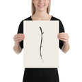 Minimalist sumi-e ink design of a single drooping willow twig printed on an art print. 12″×16″ size.