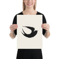 A minimalist sumi-e ink brush painting of a flying swallow on an art print. 12″×16″ size.