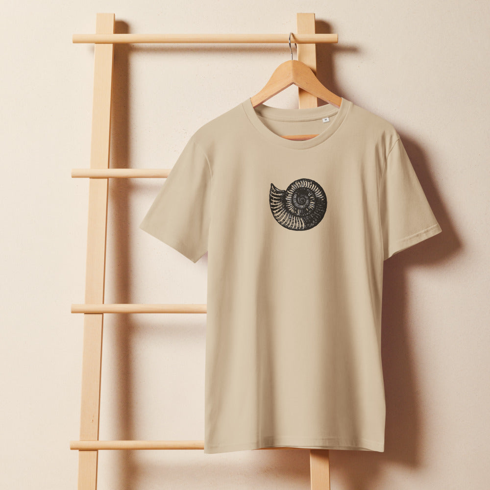 A detailed black line art illustration of a Scaphites nodosus ammonite shell on a solid color t-shirt. On a wooden hanger, Clay colourway.
