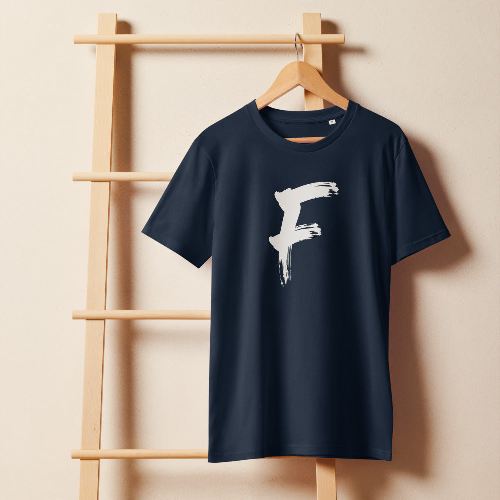 The capital letter F in bold black sumi-e brush strokes with dry-brush texture, printed on a t-shirt. On a wooden hanger, Ink colourway.