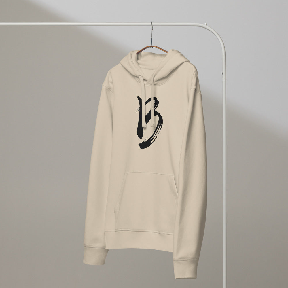 The capital letter B printed in black sumi-e ink brushstrokes on a hoodie. On a hanger, Clay colourway.